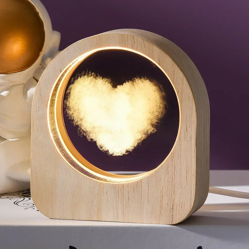 A 3D crystal laser engraved desk decor featuring an image of a heart made of clouds in an illuminated wooden frame.