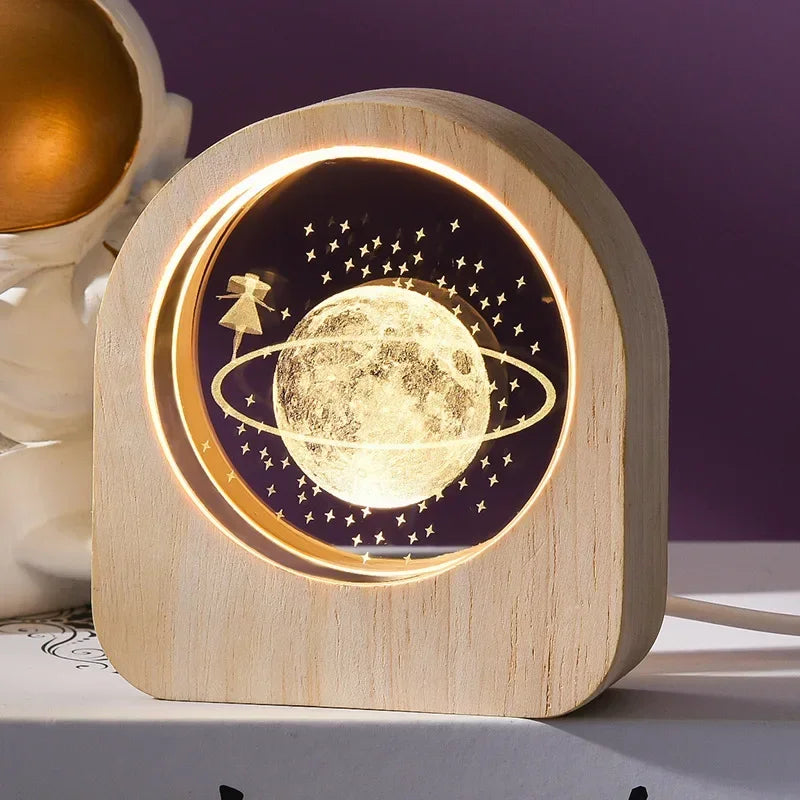 A 3D laser engraved desk decor with an image of a girl circling the moon in an illuminated wooden frame
