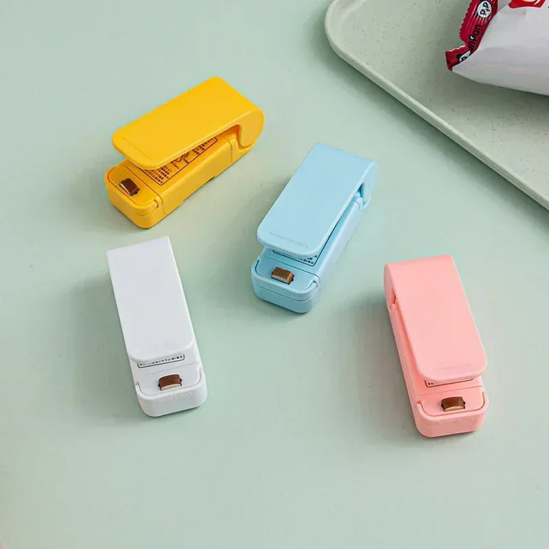 4 Magnetic bag sealers in different colors shown as blue, white, yellow, and pink on a soft background