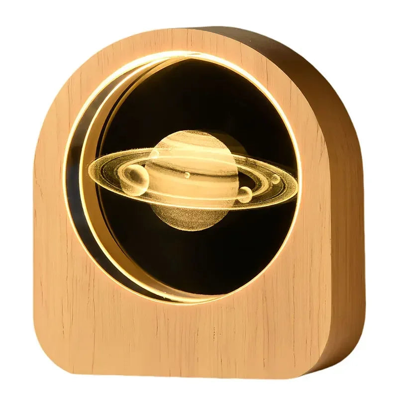 Laser engraved desk decor showing a planet with several smaller planets in its orbit on a white background