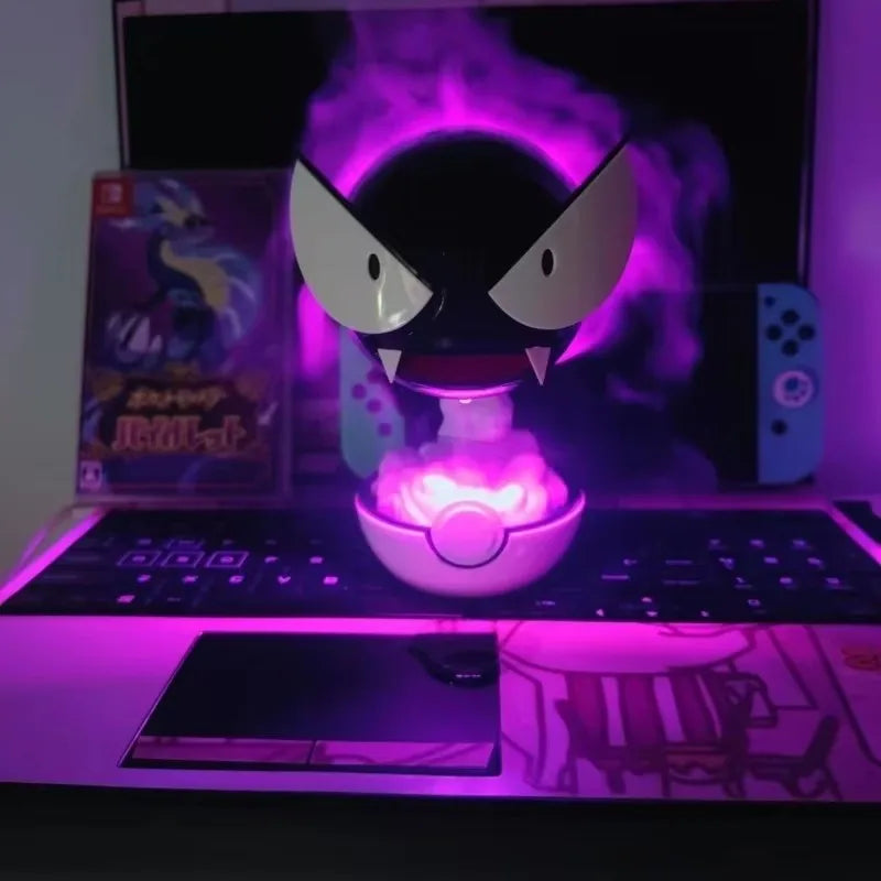 A light up humidifier of the Pokémon Ghastly in front of a computer